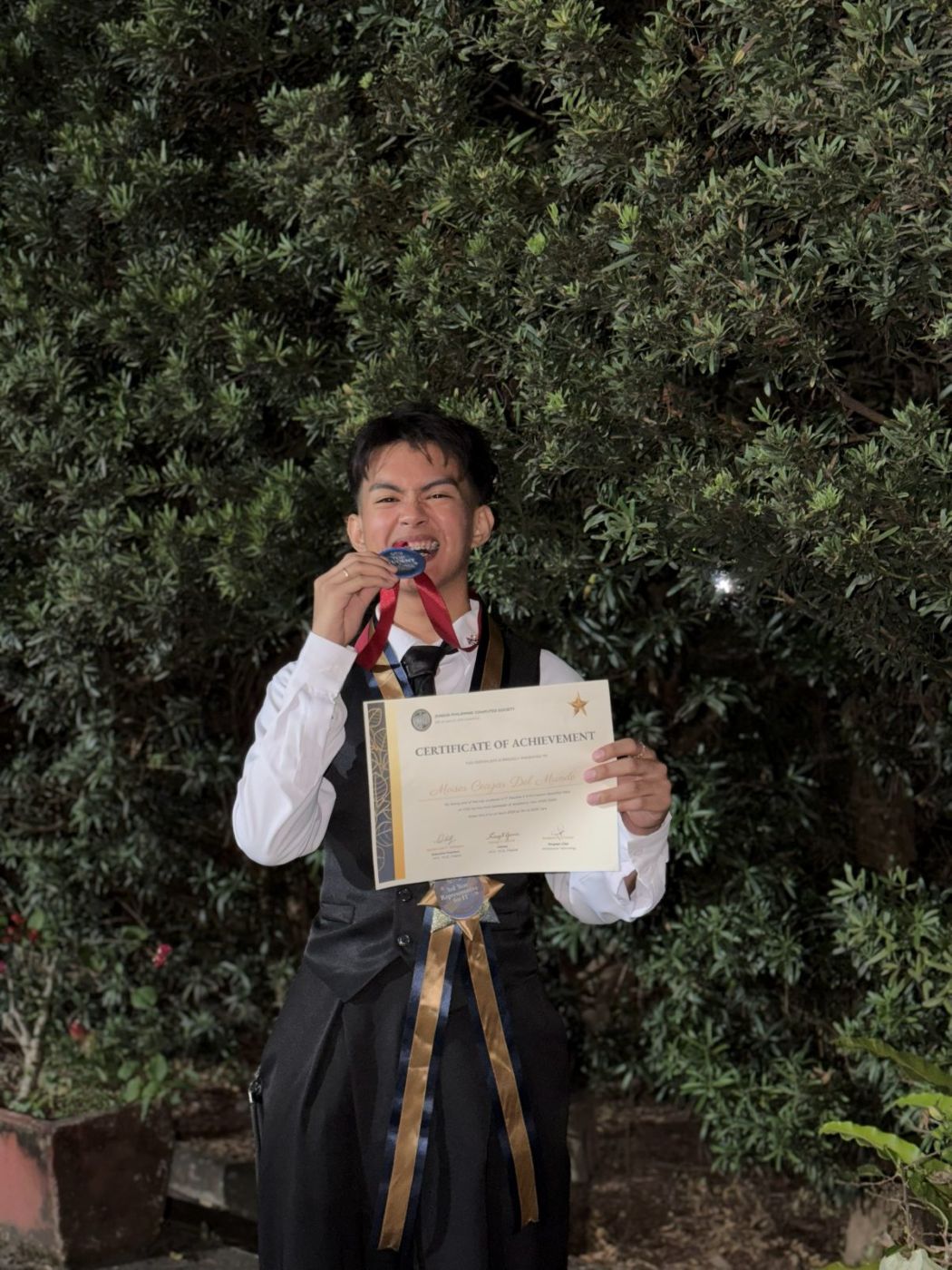 Moises with the Top Student medal and certificate